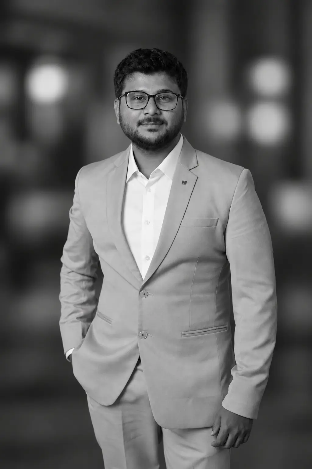 Naif Tole, founder of Aeron Interiors, in a light grey suit